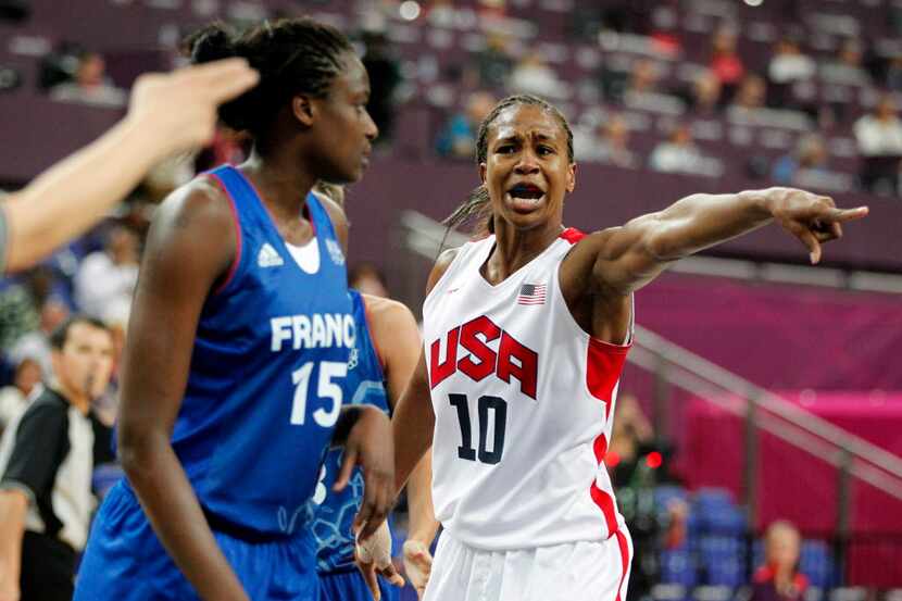 USA's Tamika Catchings (10) argues a call with an official as France's Jennifer Digbeu (15)...