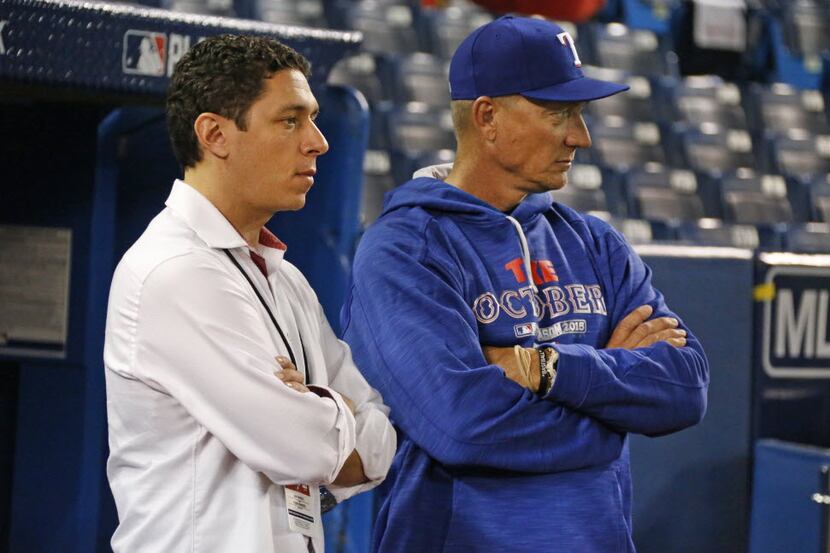 Texas general manager Jon Daniels, left, and manager Jeff Banister watch as the Rangers work...