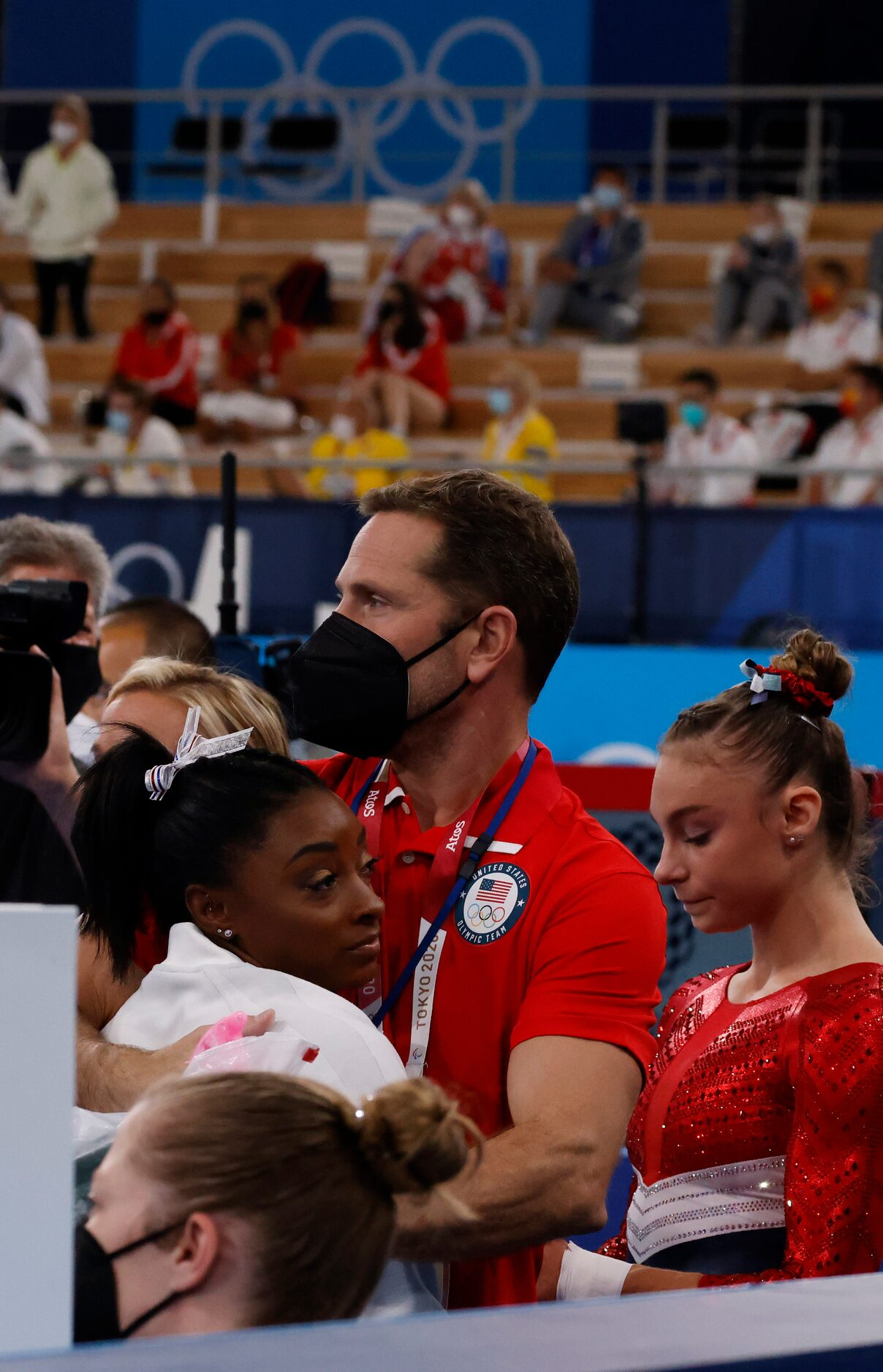 USA’s Simone Biles hugs coach Laurent Landi after returning to the field of play shortly...