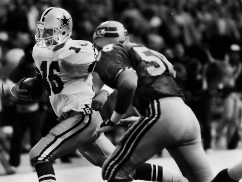 QB Steve Pelluer (16) scrambles as Seahawk Bruce Scholtz (58) closes in. (File photo)