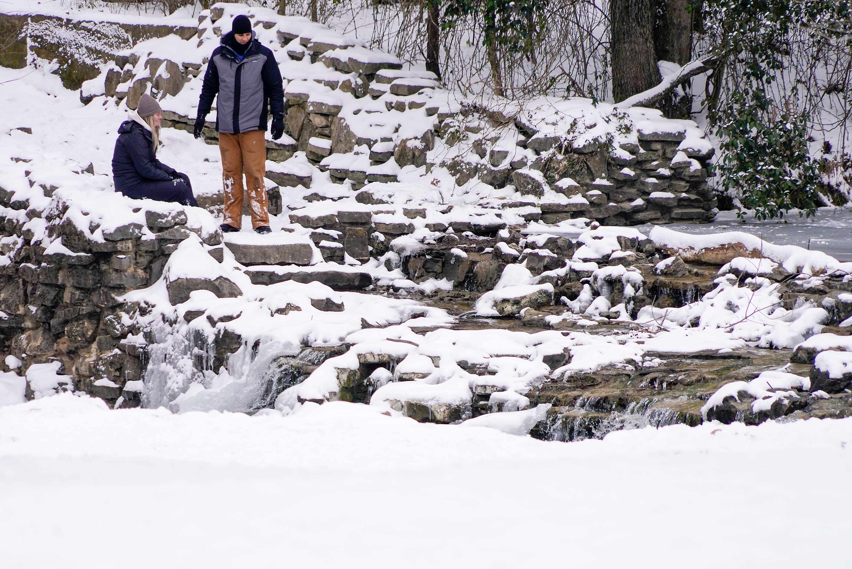 People check out the partially frozen waterfall in Prairie Creek Park after a second winter...