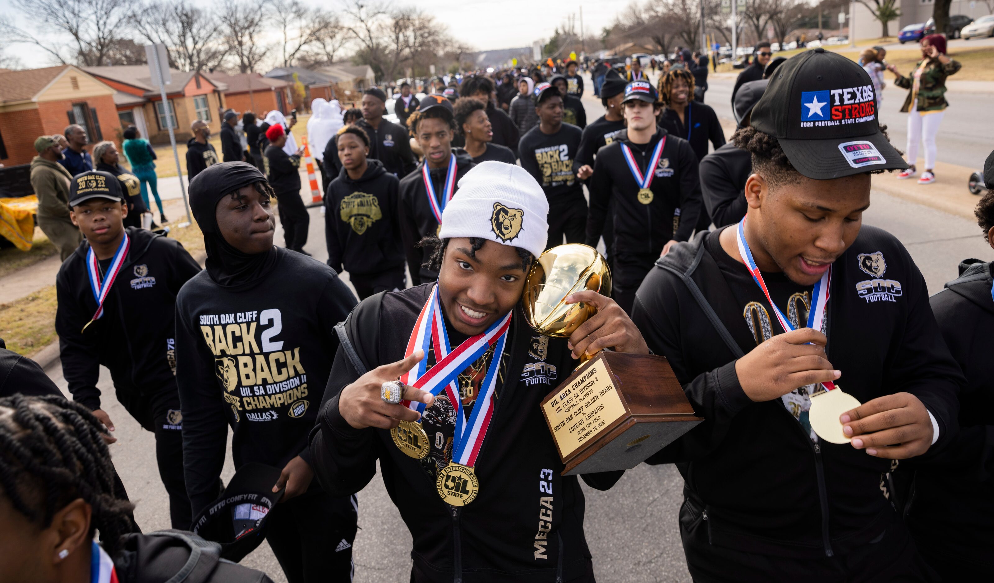 The South Oak Cliff Golden Bears cornerback Jayvon Thomas (center) holds the team area...