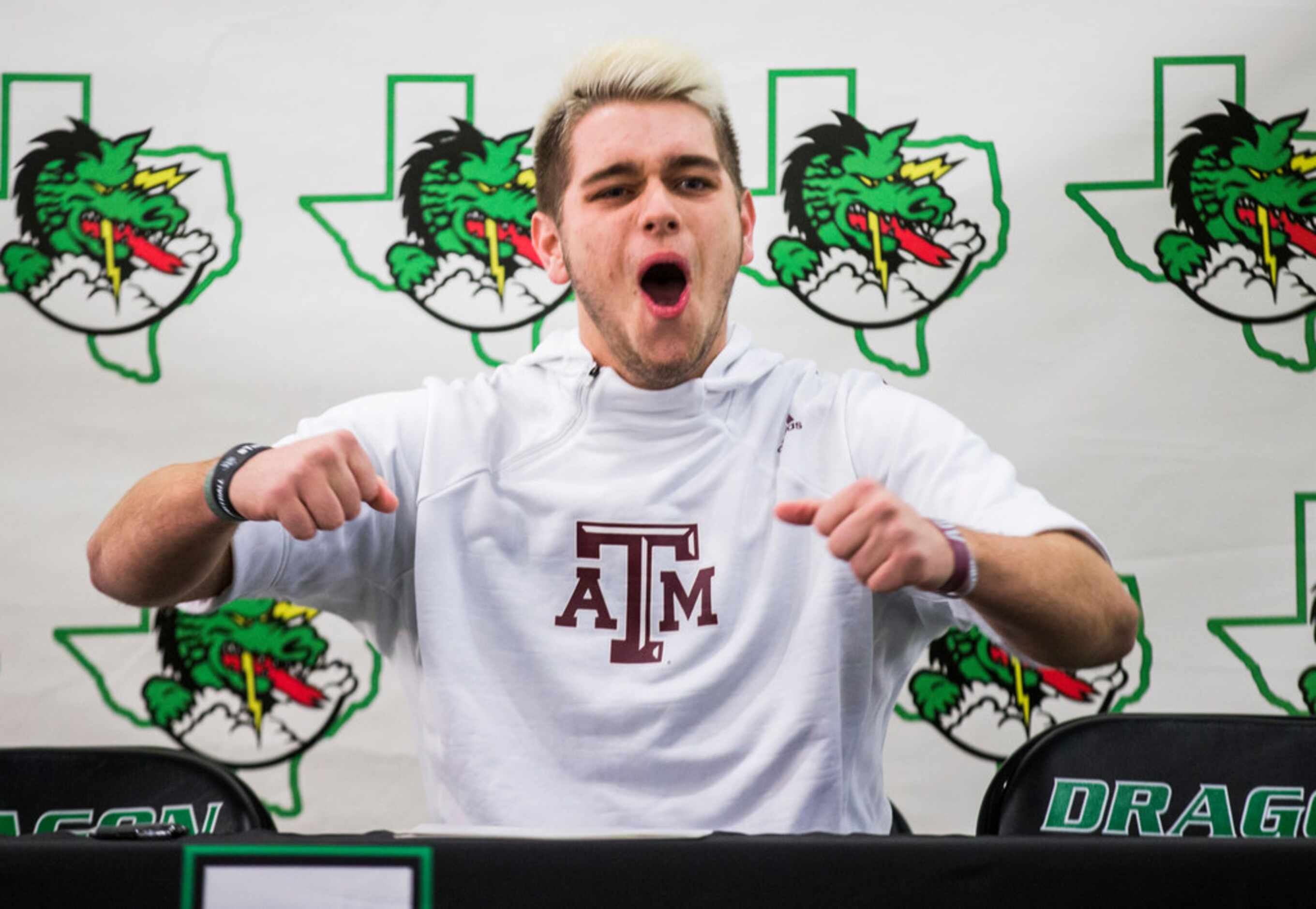 Southlake Carroll football player Blake Smith reacts after signing a national letter of...