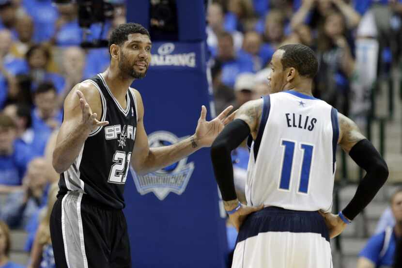 San Antonio Spurs' Tim Duncan gestures toward an official after being charged with a foul as...