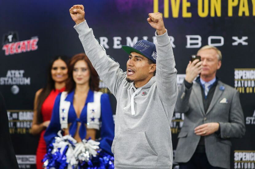 Boxer Mikey Garcia gestures to fans during the official weigh-in ahead of Saturday's IBF...