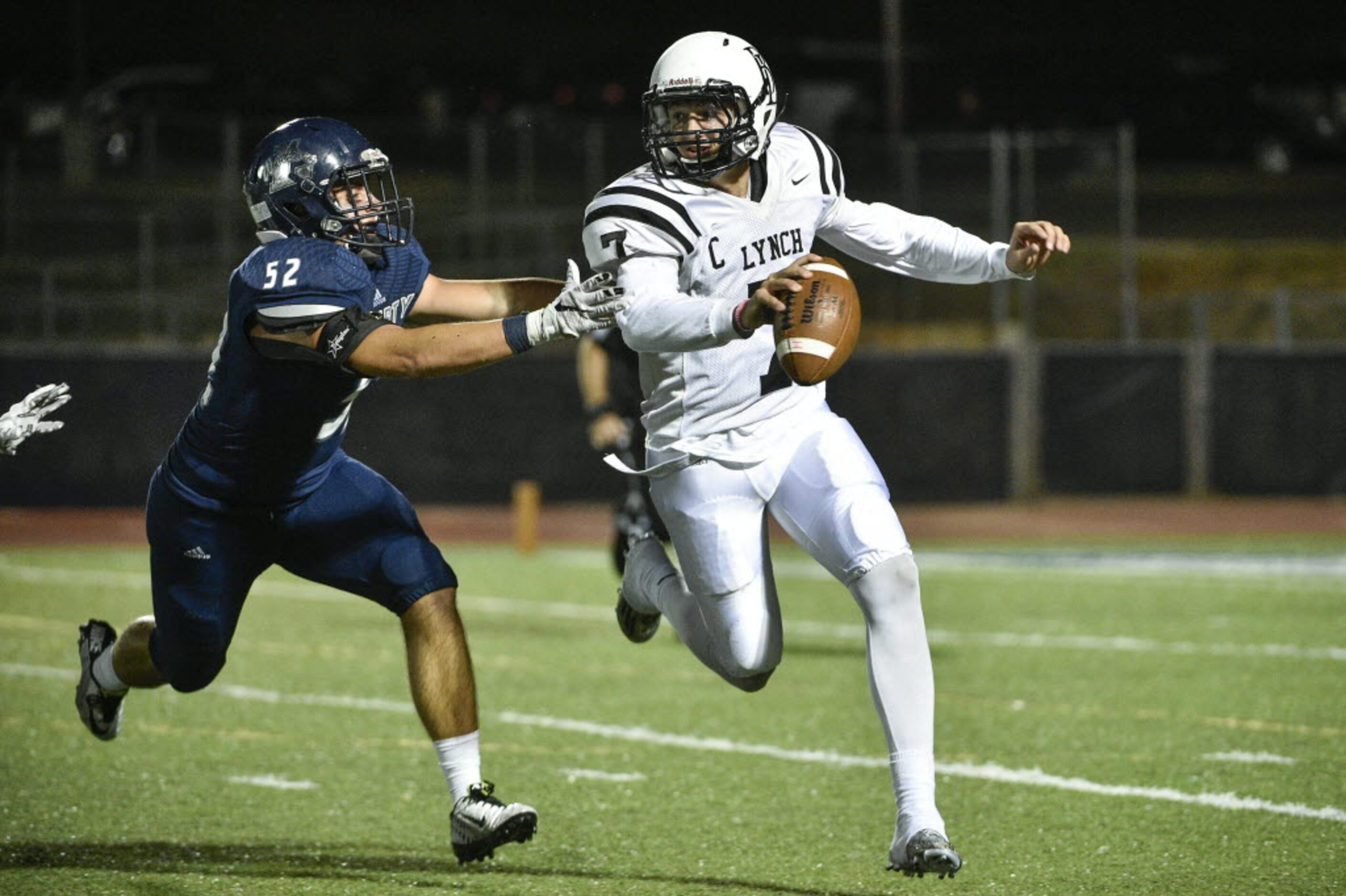 Liberty defensive lineman Will McClain (52) chases Bishop Lynch quarterback Tristan Smith...