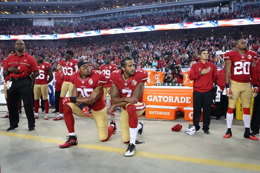 San Francisco 49ers Eric Reid (35) and Colin Kaepernick (7) take a knee during the national...