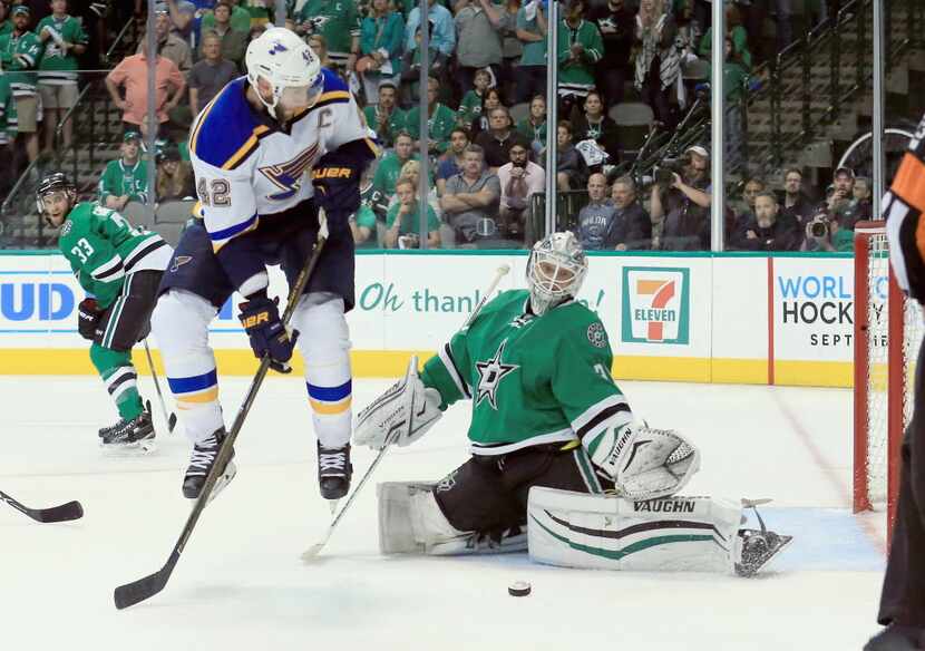 David Backes #42 of the St. Louis Blues scores the game winning goal against Antti Niemi #31...