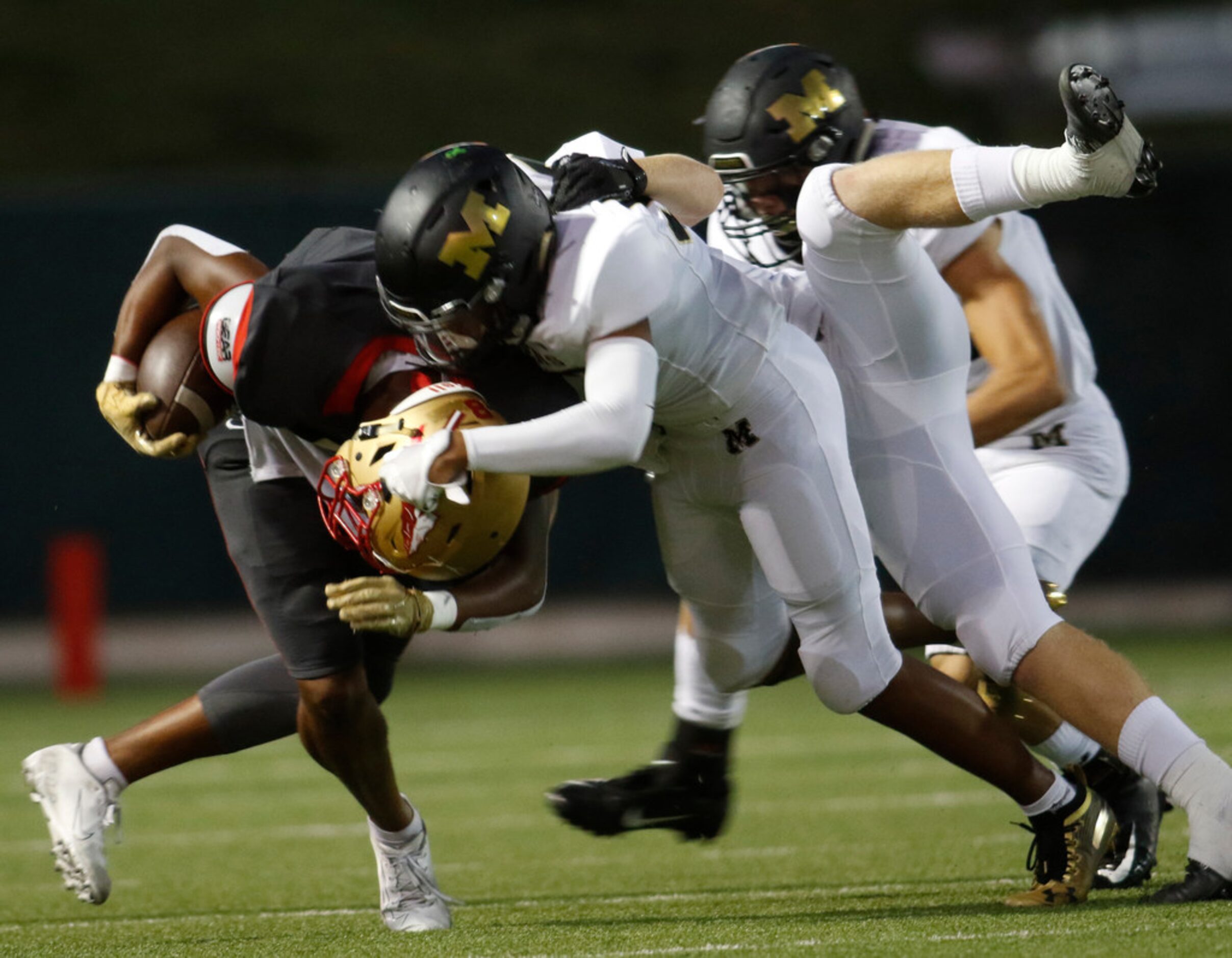 South Grand Prairie receiver Deamikkia (8) attracts the attention of Mansfield defenders...