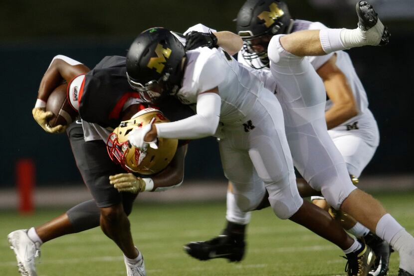 South Grand Prairie receiver Deamikkia (8) attracts the attention of Mansfield defenders...