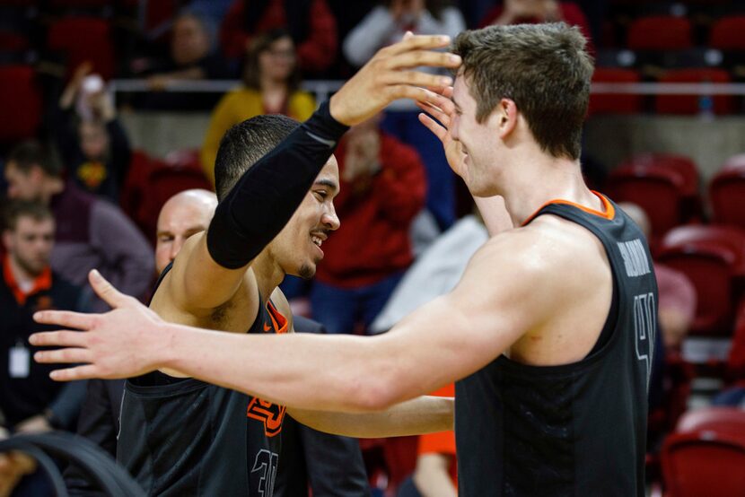 Oklahoma State's Jeffrey Carroll (30) and Mitchell Solomon (41) celebrate their victory over...