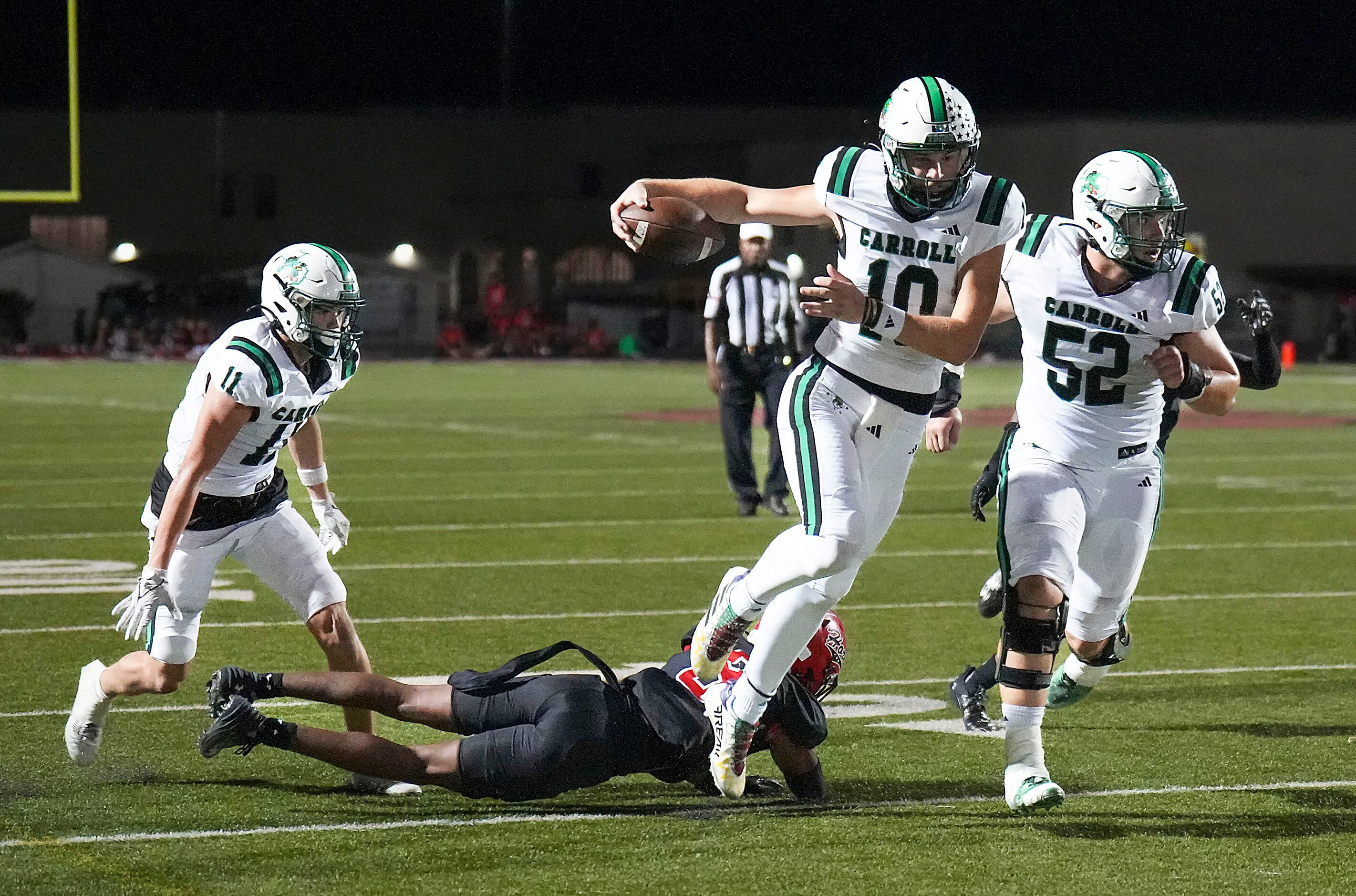 Southlake Carroll quarterback Graham Knowles (10) gets past Cedar Hill cornerback Trysten...