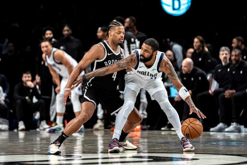 Dallas Mavericks guard Kyrie Irving, right, is defended by Brooklyn Nets guard Dennis Smith...