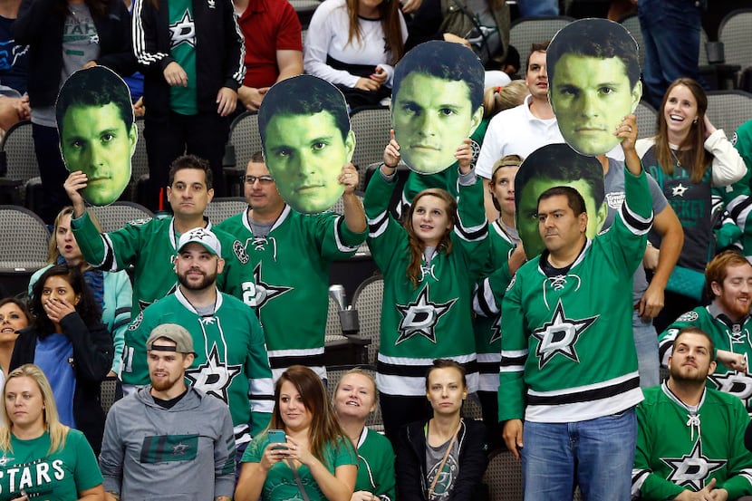 Dallas Stars fans wave cutouts of left wing Antoine Roussel (21) during the third period...