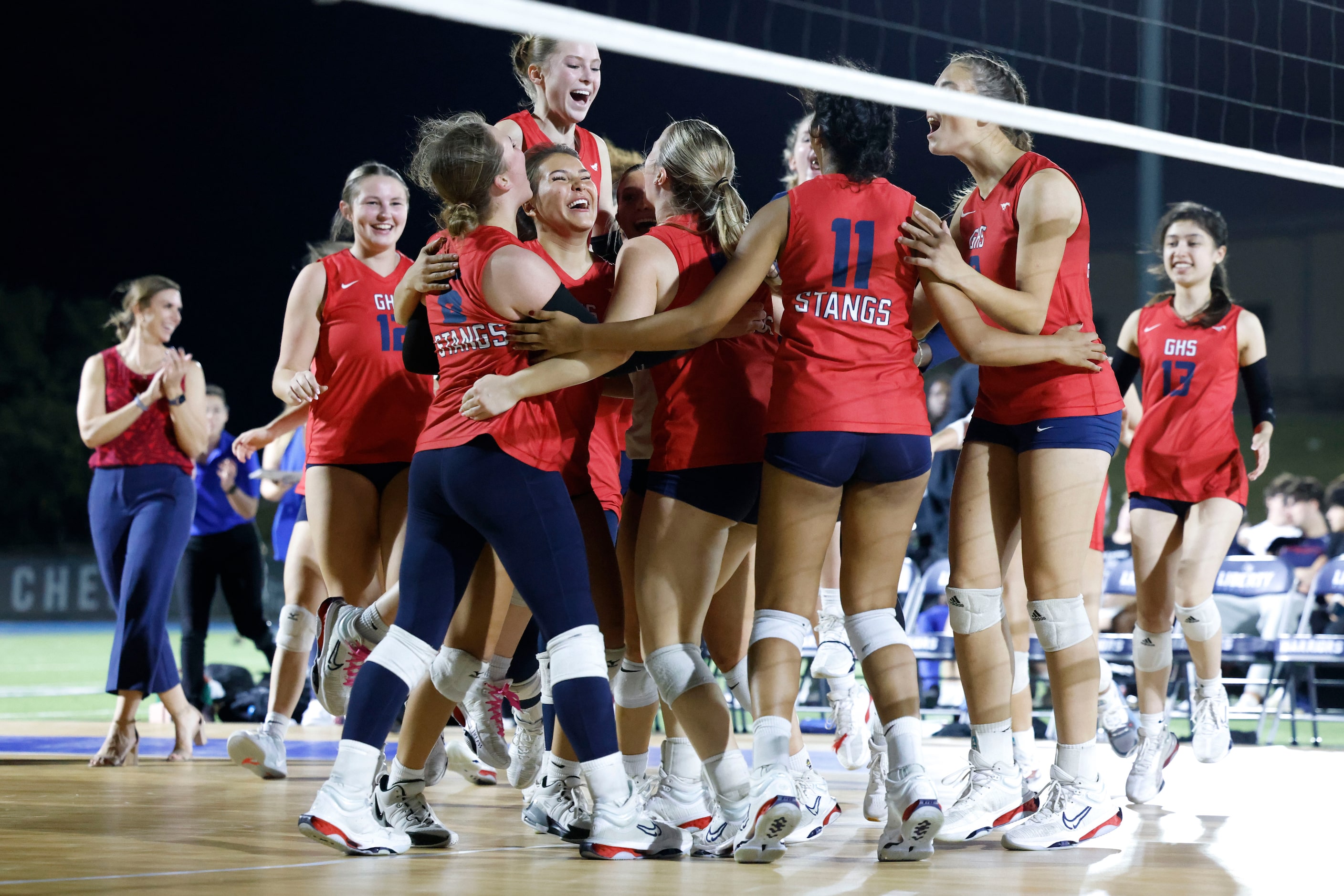 Grapevine High’s players celebrate their win in an outdoor volleyball game against Liberty...