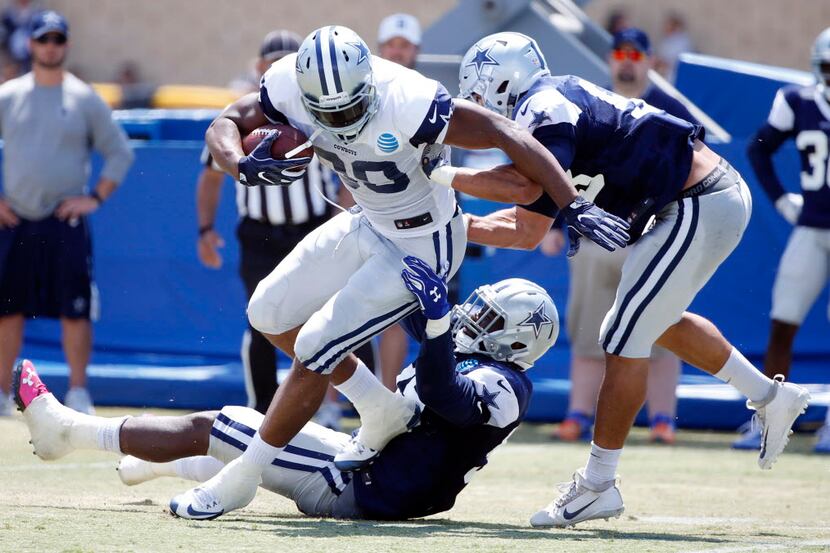 Dallas Cowboys tight end Rico Gathers (80) is brought down by Dallas Cowboys defensive end...
