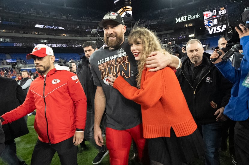 FILE - Kansas City Chiefs tight end Travis Kelce and Taylor Swift walk together after an AFC...