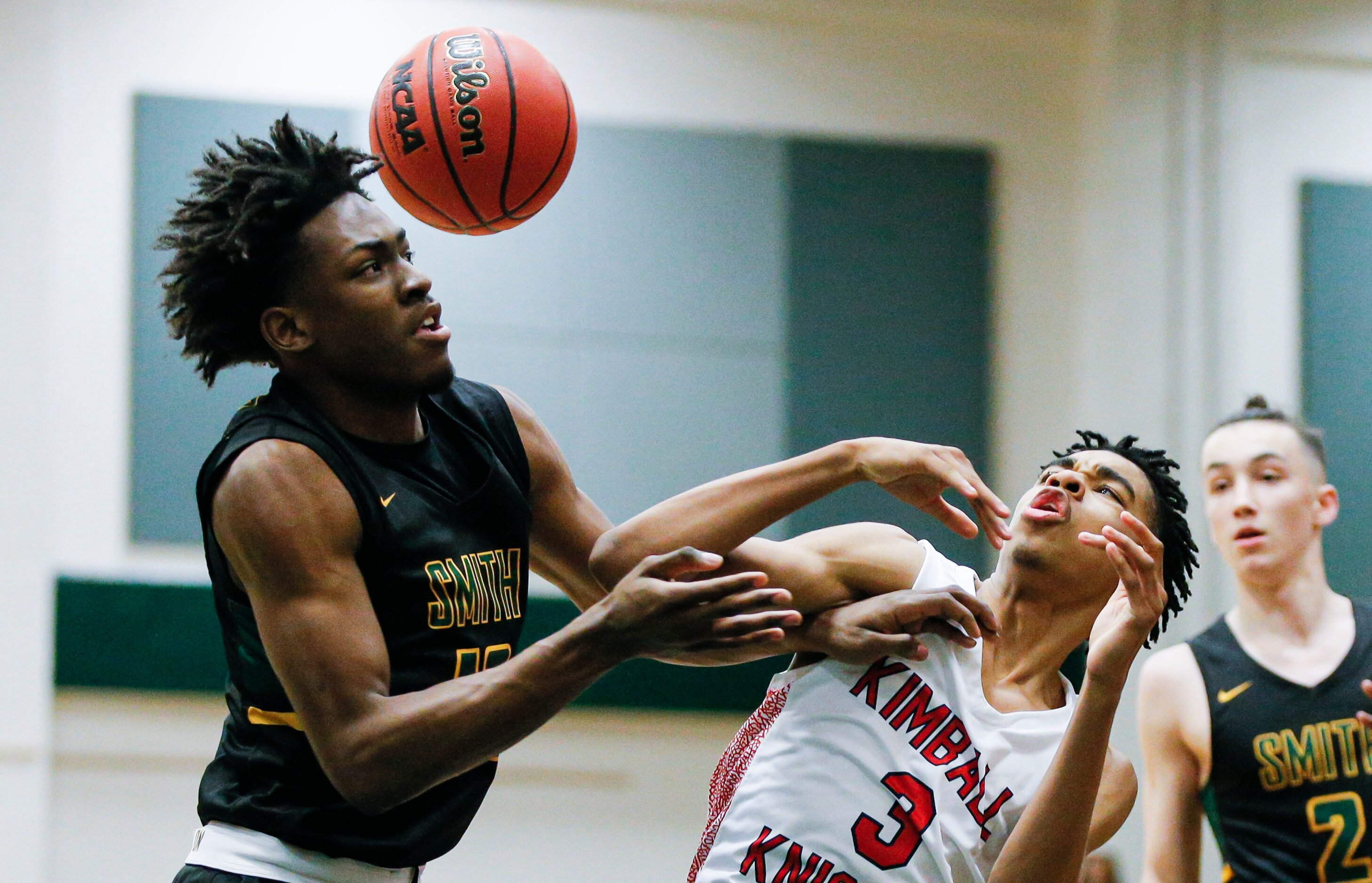 Newman Smith senior Ke'Shon Weakley, left, and Kimball junior DJ Pigford battle for the ball...