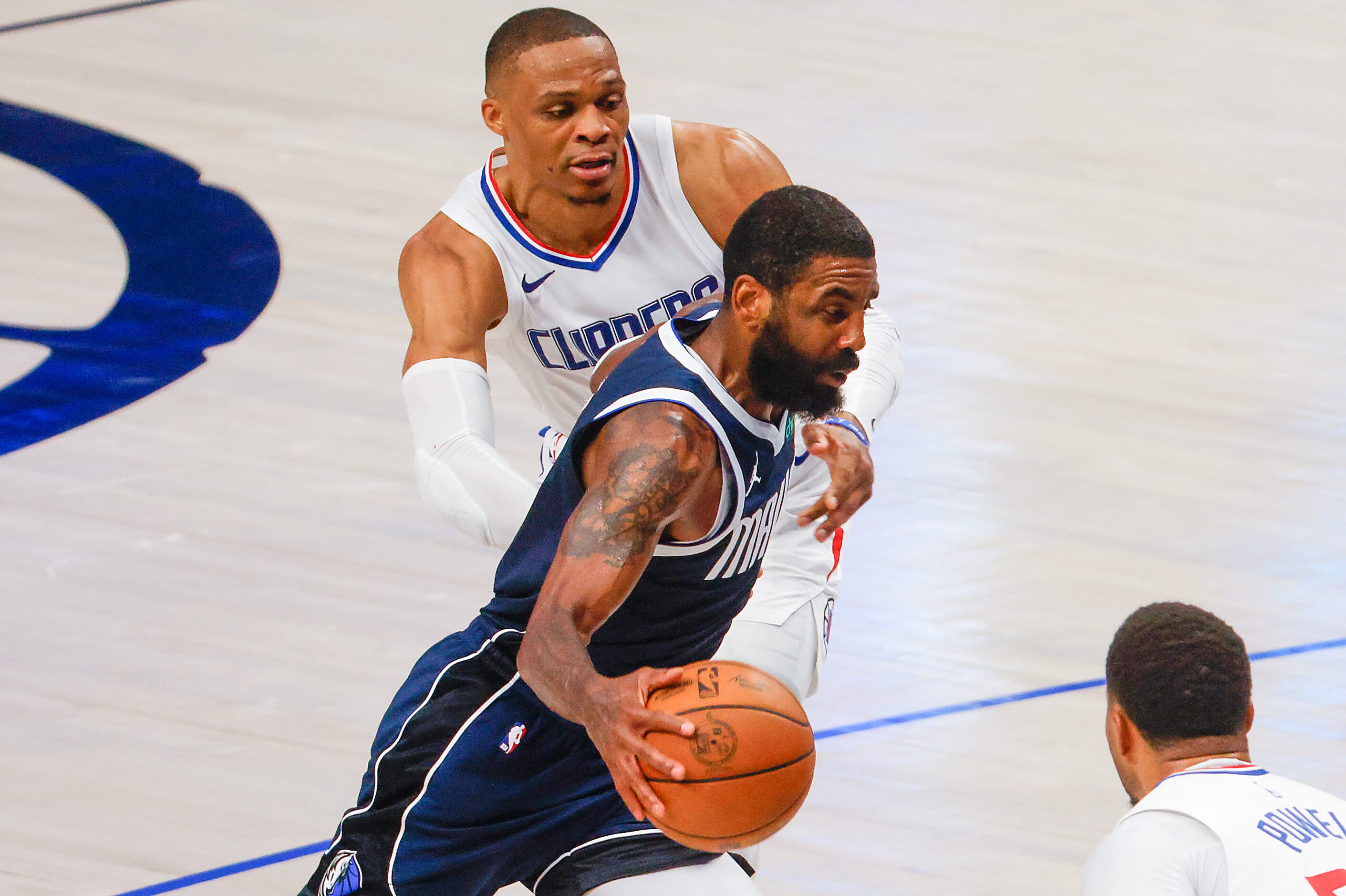 Dallas Mavericks guard Kyrie Irving gets past LA Clippers guard Russell Westbrook during the...