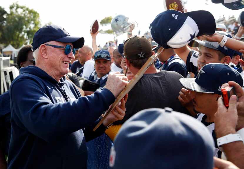 Dallas Cowboys owner and general manager Jerry Jones gives out his autograph during the...