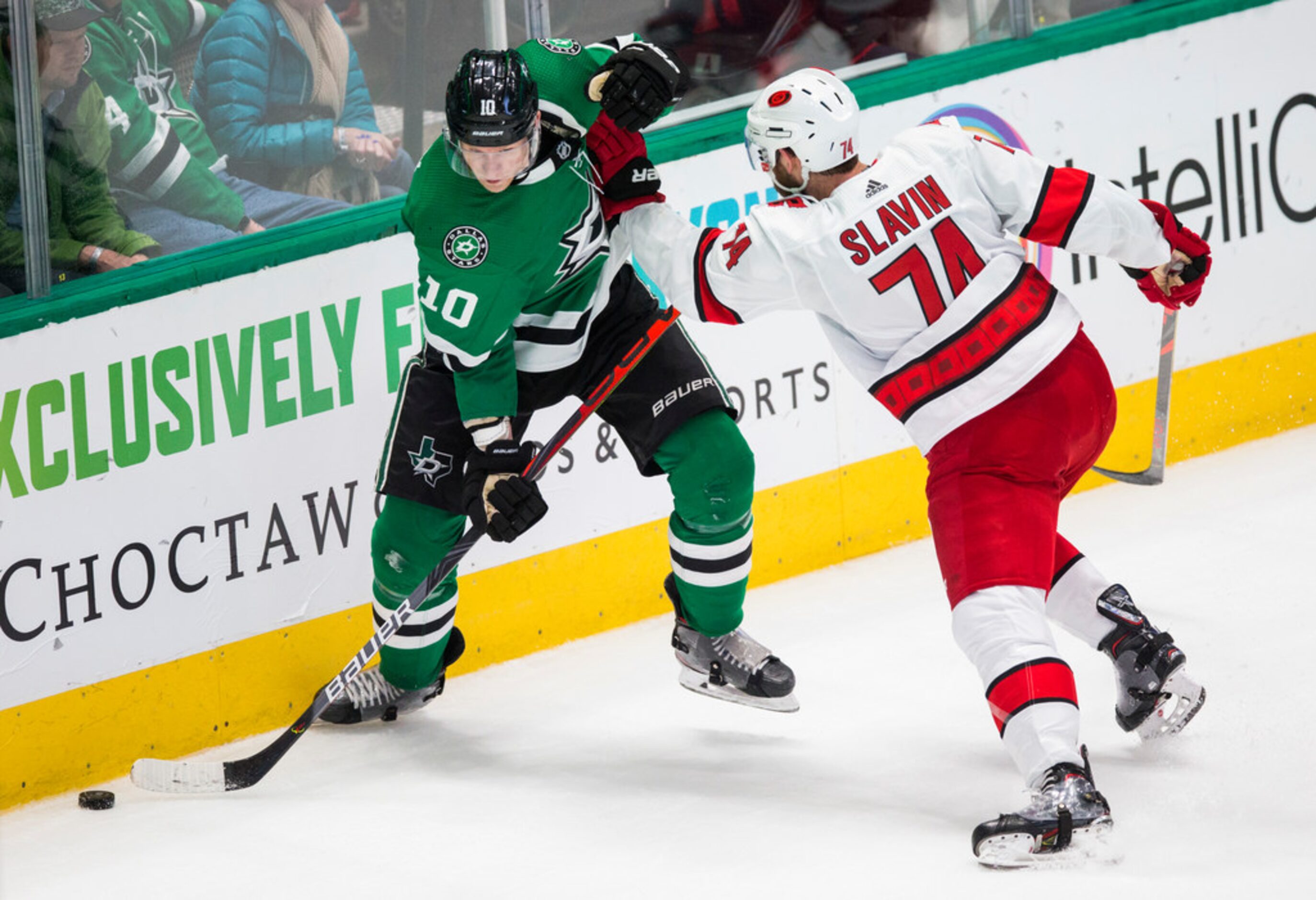 Dallas Stars right wing Corey Perry (10) is pushed by Carolina Hurricanes defenseman Jaccob...