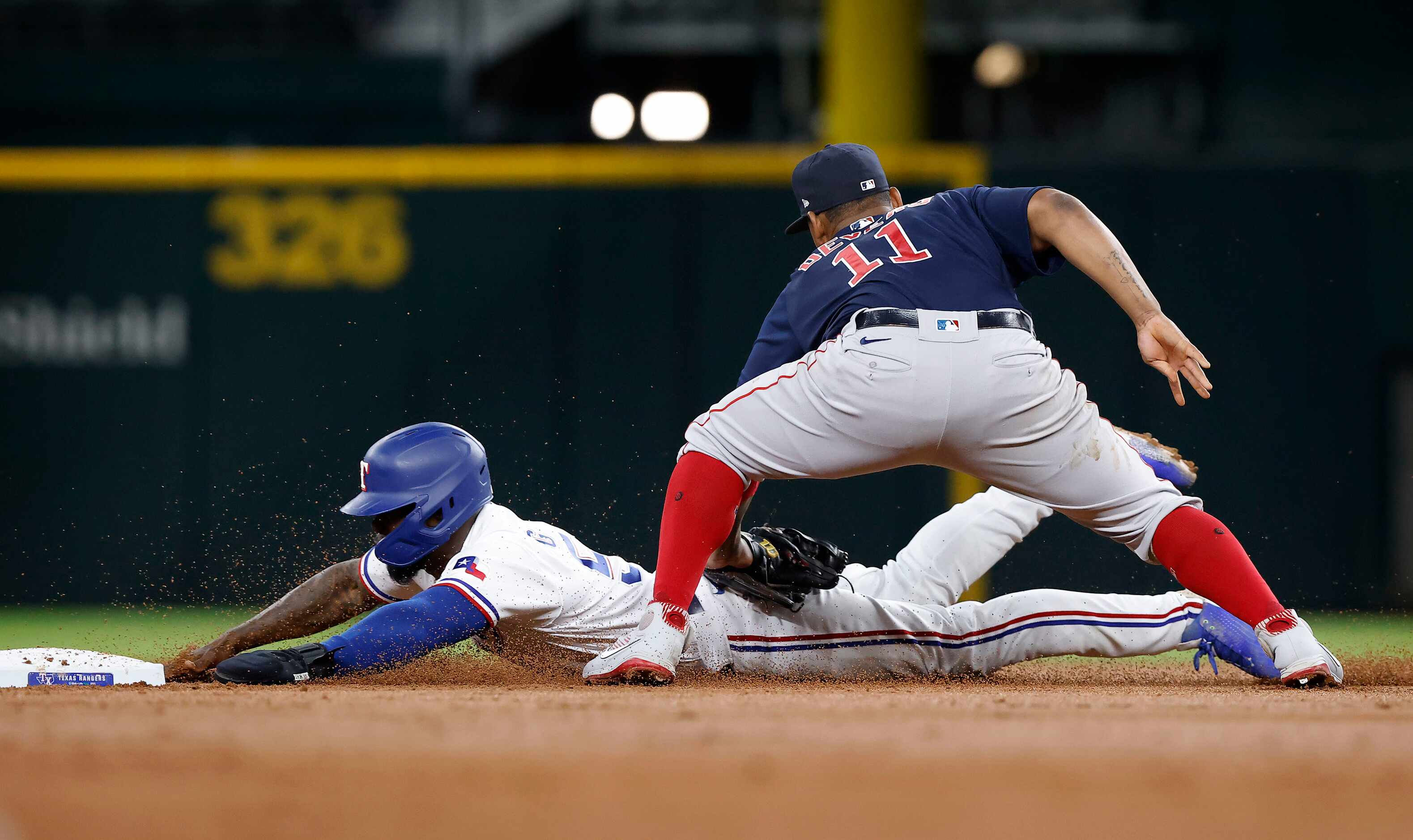 Boston Red Sox third baseman Rafael Devers (11) tags out Texas Rangers Adolis Garcia (53) on...