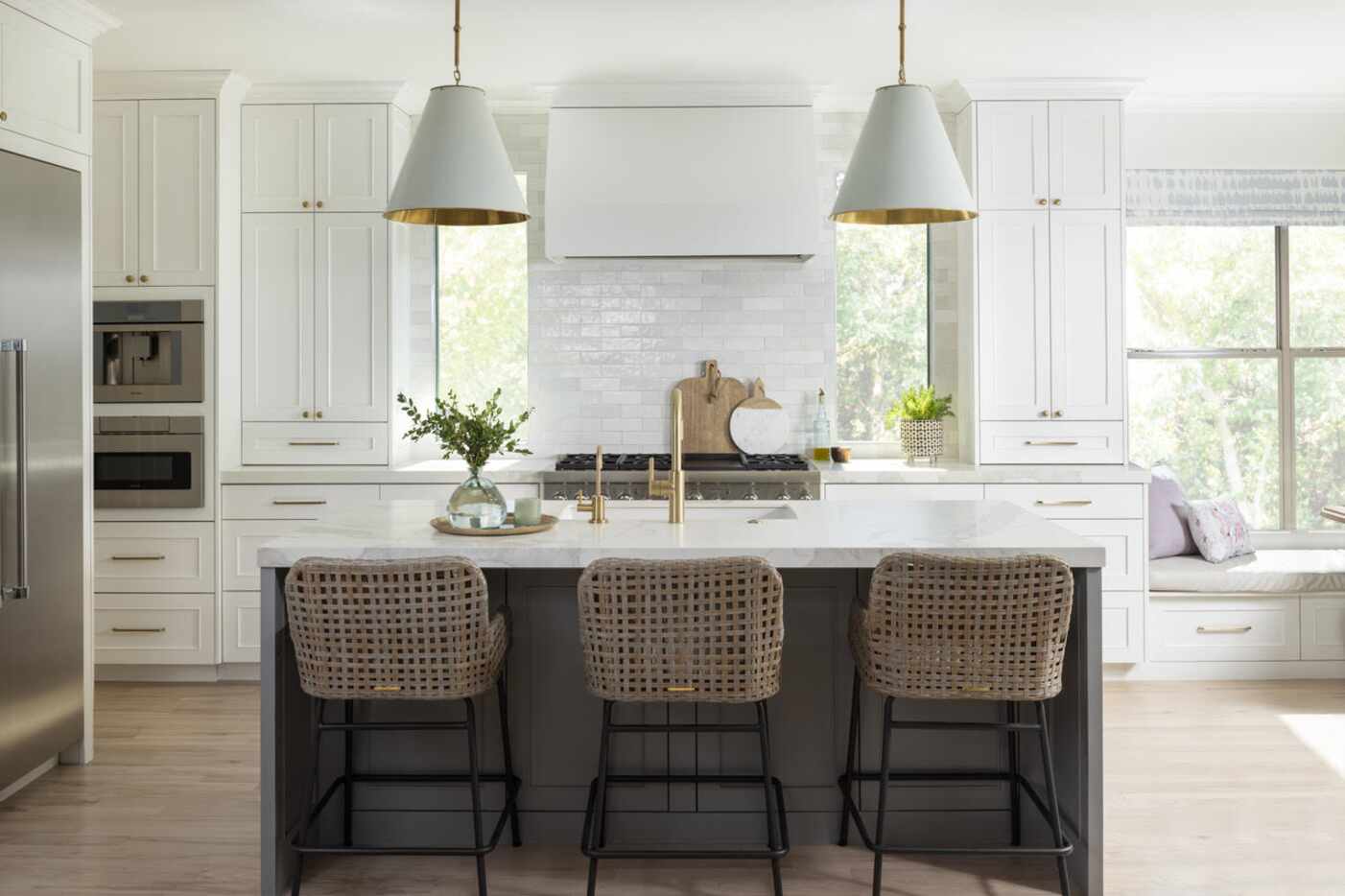 A white kitchen features a large island
