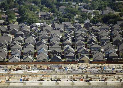 In an aerial view, you can make out an established neighborhood, new homes and homes under...