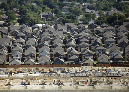 In an aerial view, you can make out an established neighborhood, new homes and homes under...