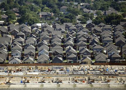 In an aerial view, you can make out an established neighborhood, new homes and homes under...