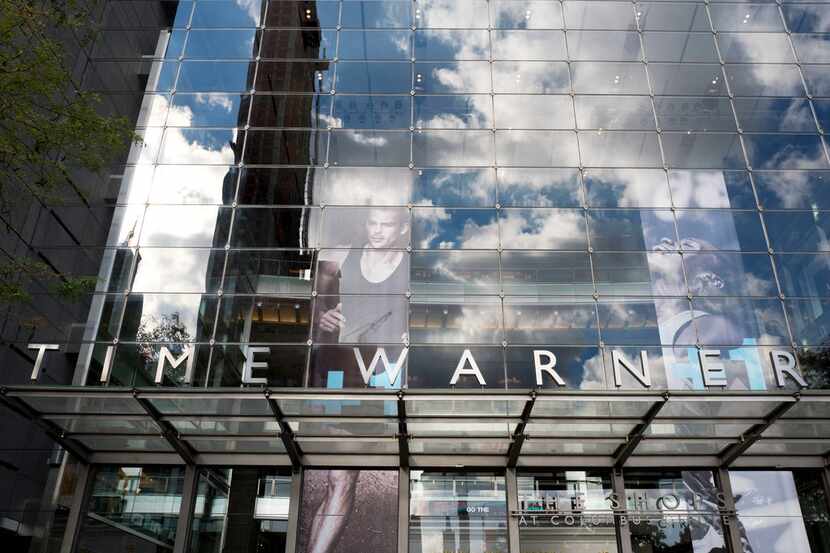 Clouds are reflected in the glass facade of the Time Warner building in New York. 