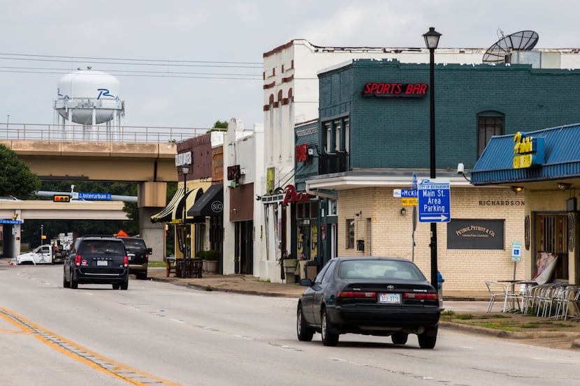 Vehicles drive through the 100 block of East Main Street in old downtown Richardson, an area...