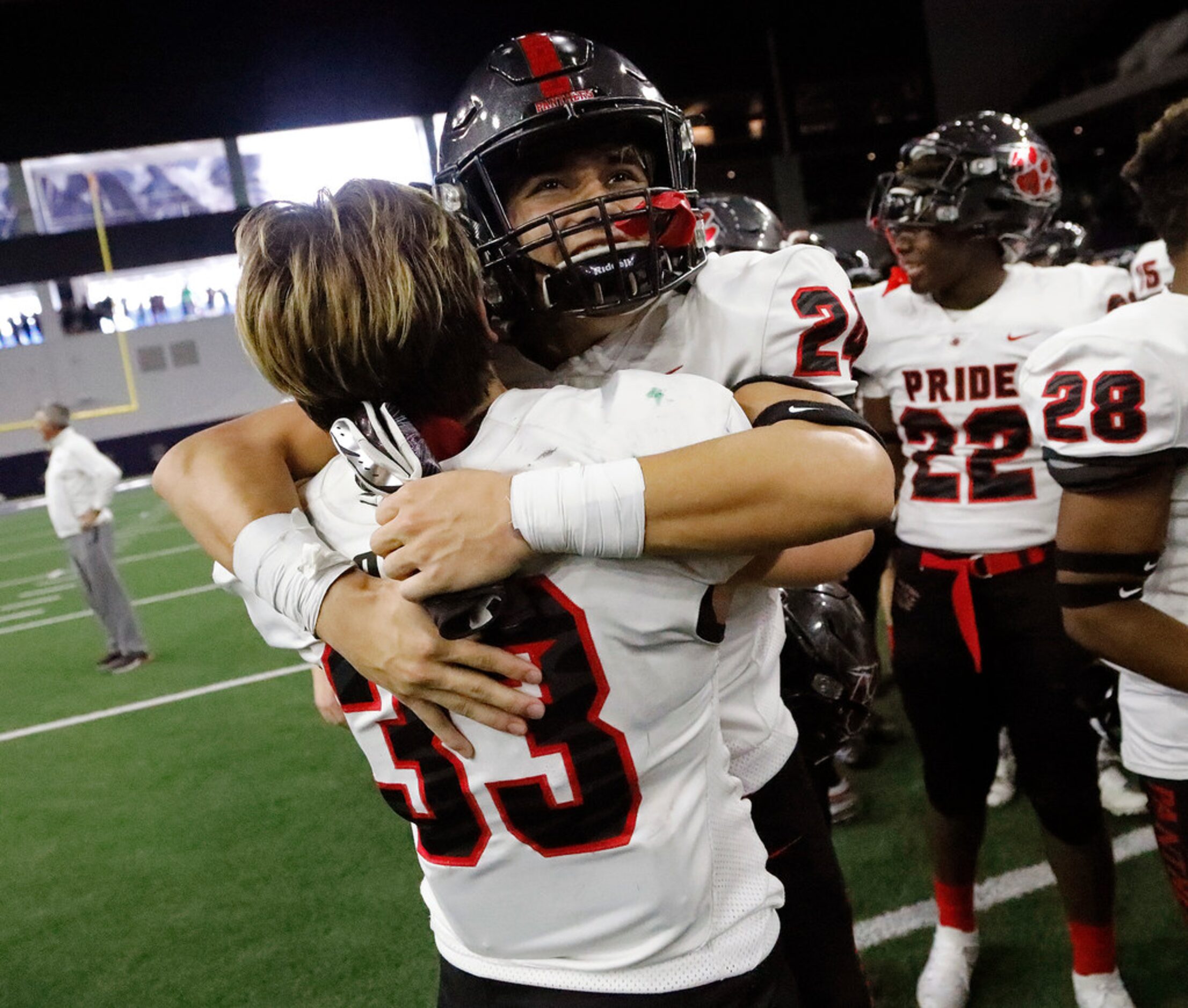 Colleyville Heritage High School linebacker Matthew Powers (33) embraces Colleyville...