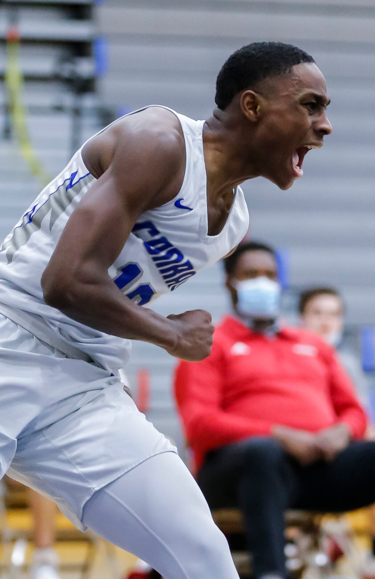 Conrad senior forward Kerric Saunders (10) celebrates dunking during a high school...