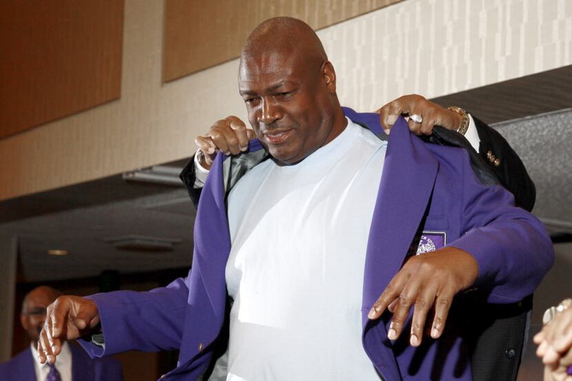 Charles Haley slips into a hall of fame jacket at the enshrinement luncheon of the Texas...