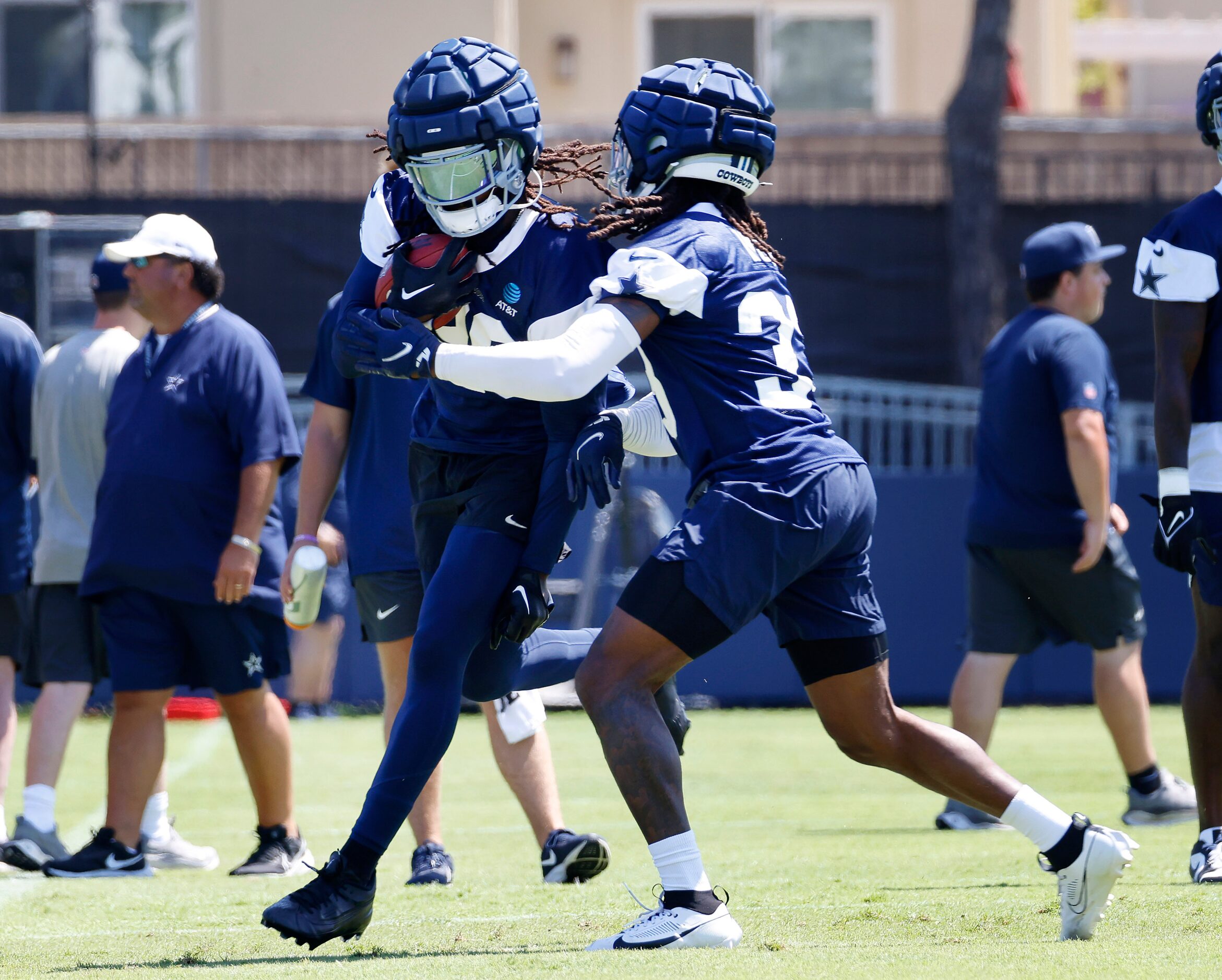 Dallas Cowboys safety Malik Hooker (28) carries the ball as he’s covered by cornerback Eric...