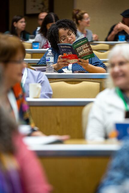 An attendee of the Mayborn Literary Nonfiction Conference flips through the program of...