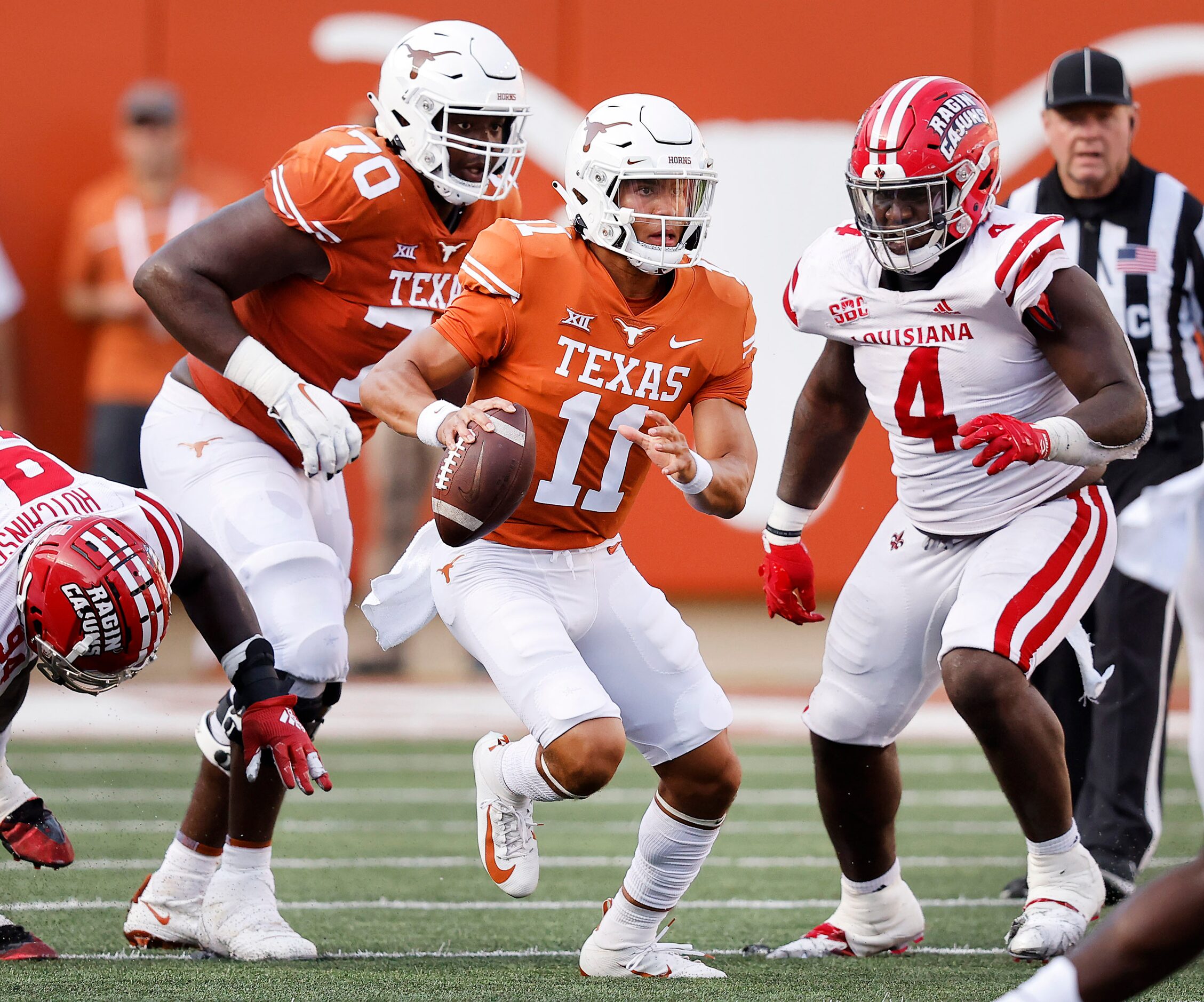 Texas Longhorns quarterback Casey Thompson (11) escapes the Louisiana-Lafayette Ragin Cajuns...