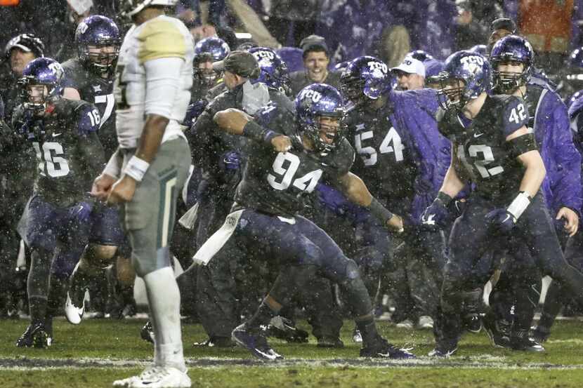 TCU Horned Frogs defensive end Josh Carraway (94) celebrates with teammates after the...