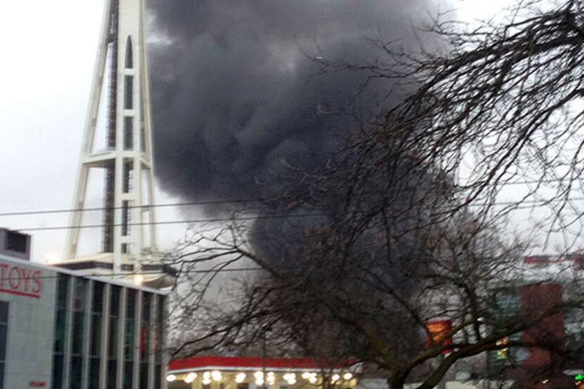 In this photo provided by KIRO- TV,  black smoke billows skyward from the scene of a...