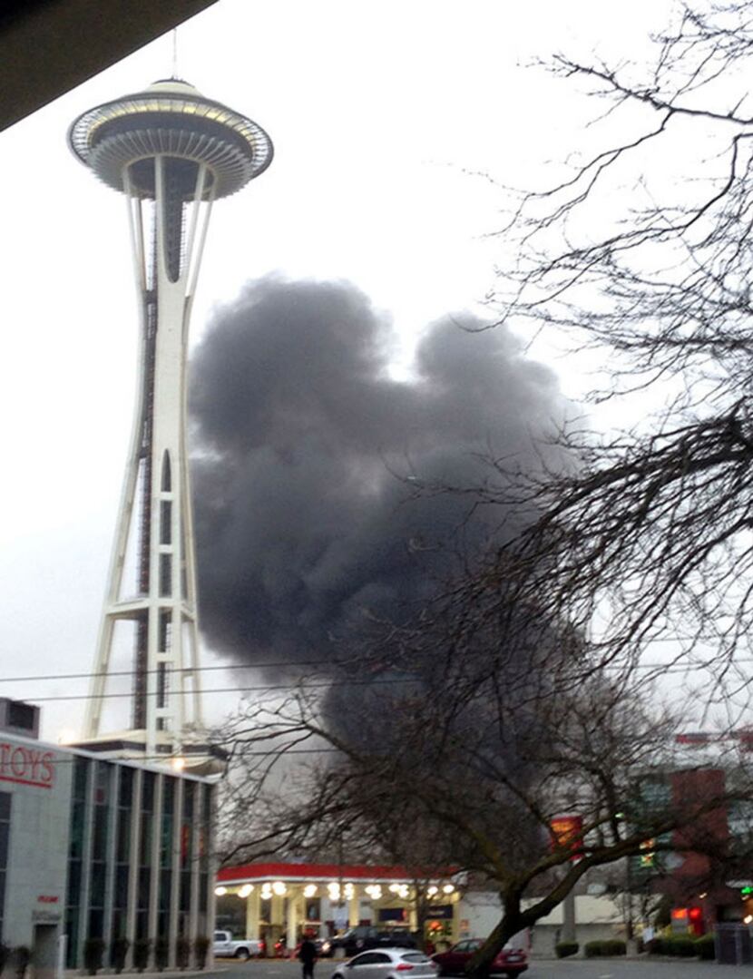 In this photo provided by KIRO- TV,  black smoke billows skyward from the scene of a...