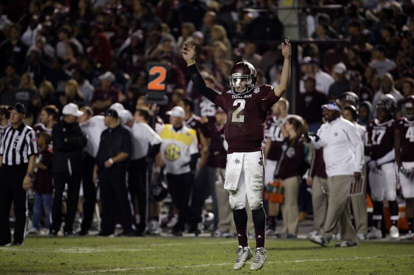 Texas A&M quarterback Johnny Manziel encourages the crowd during what was likely his final...