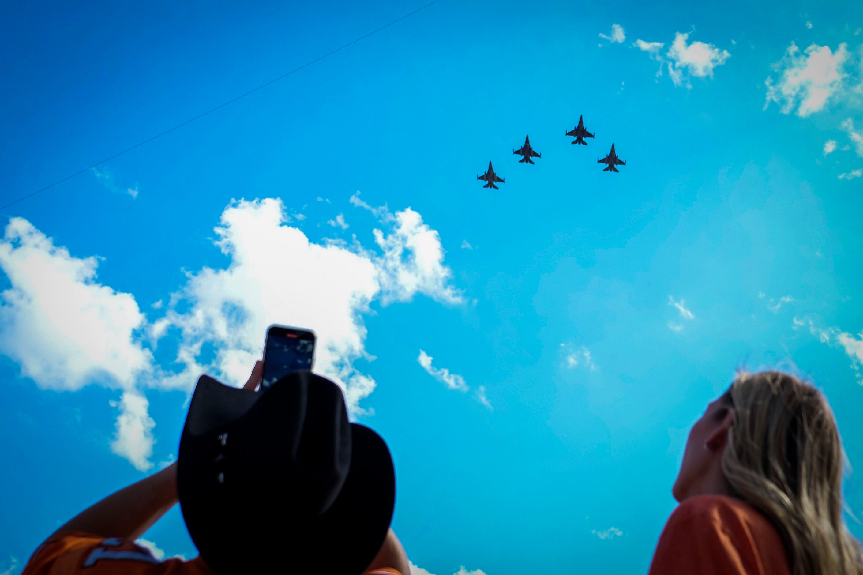 Oklahoma State fans watch a pregame flyover before an NCAA football game against TCU on...