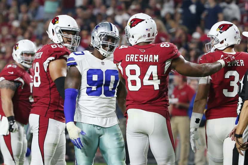 Dallas Cowboys defensive end Demarcus Lawrence (90) smiles after putting pressure on Arizona...