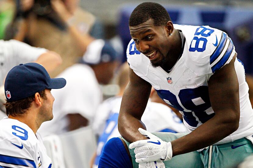 Dallas Cowboys wide receiver Dez Bryant (88) talks with quarterback Tony Romo on the bench...