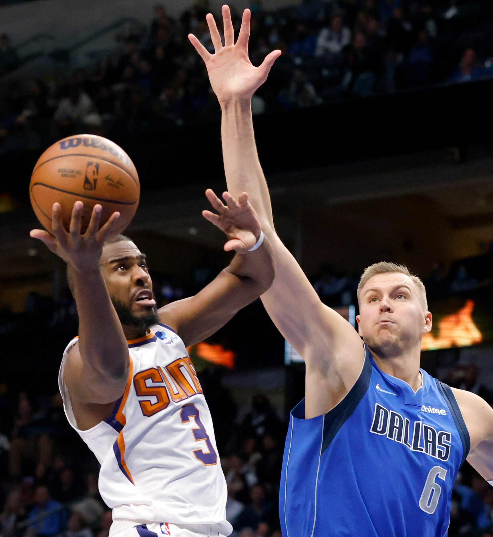 Dallas Mavericks center Kristaps Porzingis (6) tries to defend Phoenix Suns guard Chris Paul...