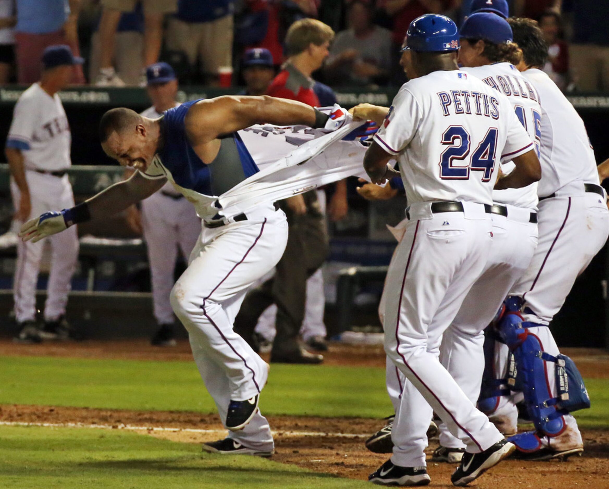 Teammates rip the jersey off of Texas third baseman Adrian Beltre after his walk-off homer...