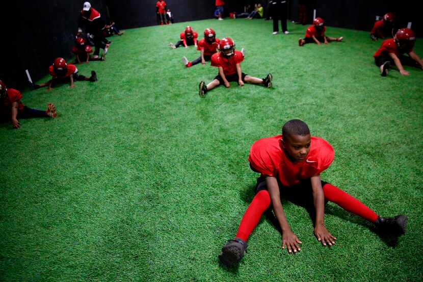 Marquay Jerrels, 8, stretches with his team during a Hamilton Park Bobcats practice. The 7-...