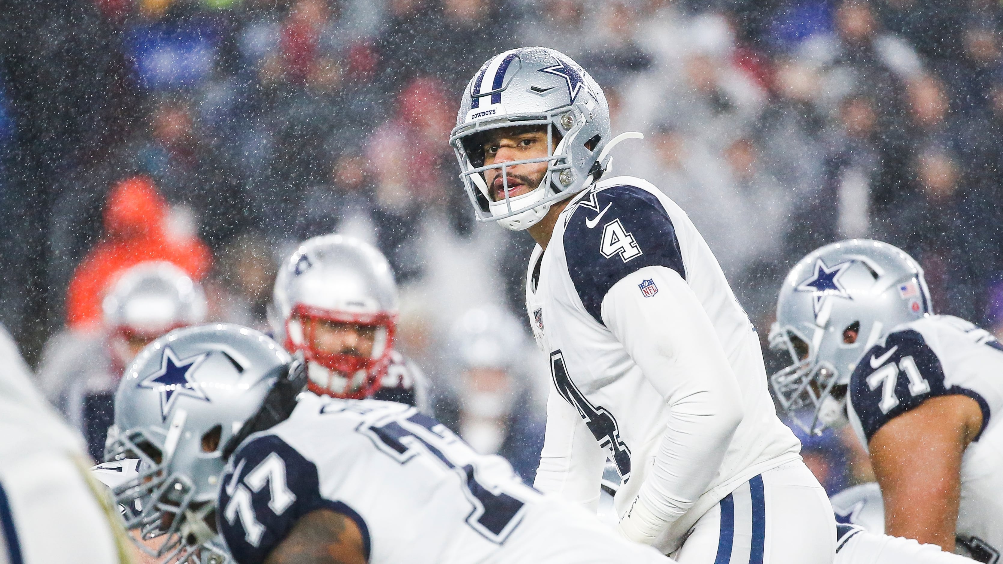 Fans wear rain gear prior to an NFL football game between the New