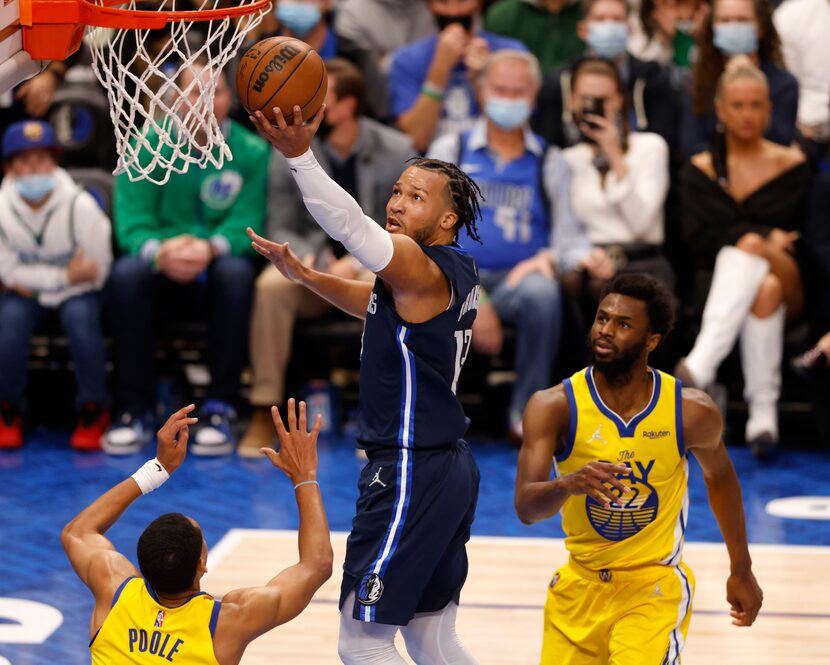 Dallas Mavericks guard Jalen Brunson (13) takes a shot in between Golden State Warriors...